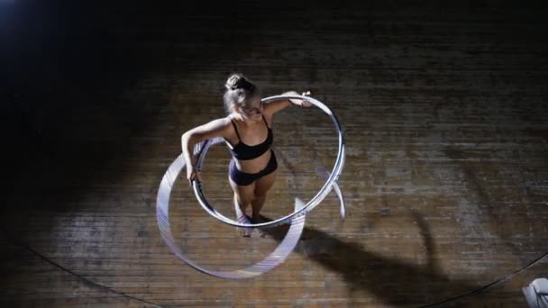 Sanat jimnastik. El becerisi kadın olay yerinde birçok hula hoop döndürün. Üstten Görünüm. — Stok video