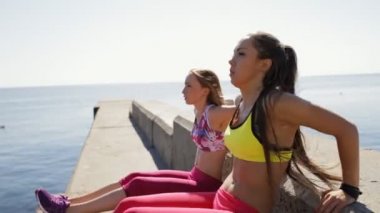Deniz iskelede sportif kız egzersiz yaparken egzersiz