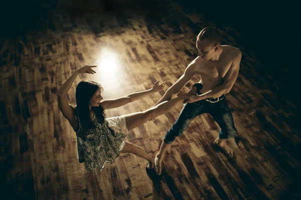 Couple dancing contemporary on floor, top view