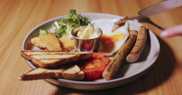 Female hand dip a grill sausage in sauce — Stock Video