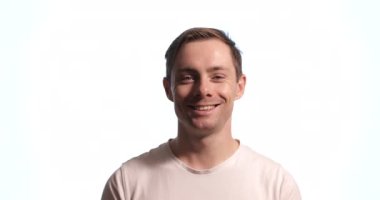 Beyaz arka planda izole edilmiş gülümseyen genç adam.