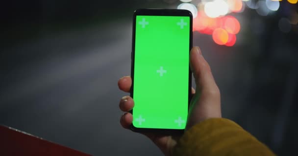 POV, male hand holding smartphone mockup at the night — Stock Video