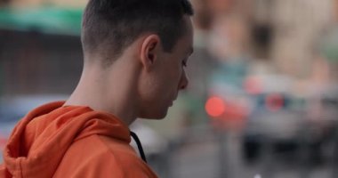 Man puts on earphones on the street