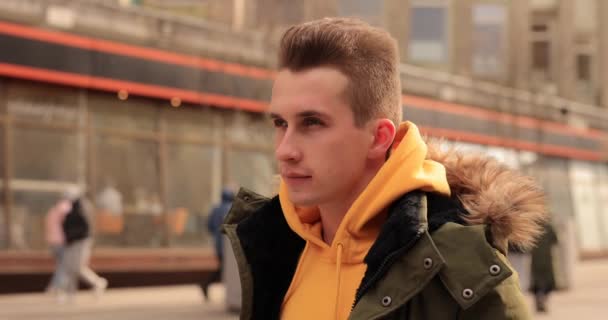 Stylish man puts on wireless earbuds into his ears — Αρχείο Βίντεο