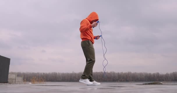 Young man skipping rope jumping outdoor — Stock video