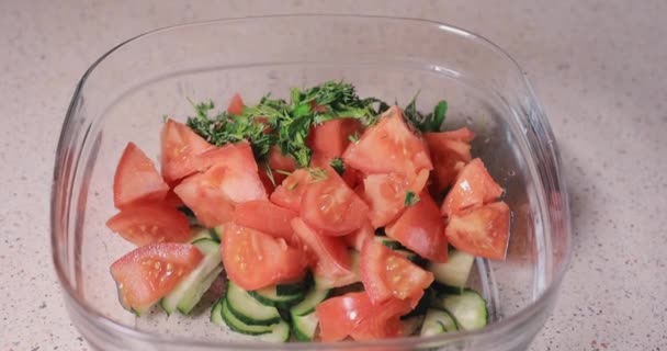 Pouring dill and parsley into the bowl — Stock Video