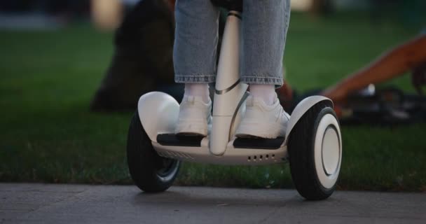 Closeup of teen girl standing and riding on segway — Stock Video