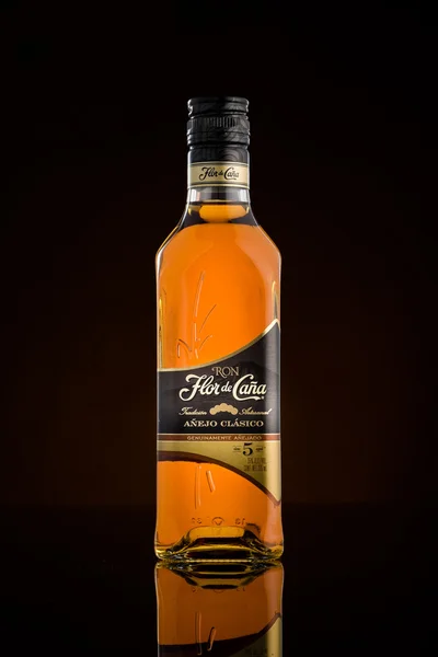 Bottle of Flor de Cana from Nicaragua on a dark background — Stock Photo, Image