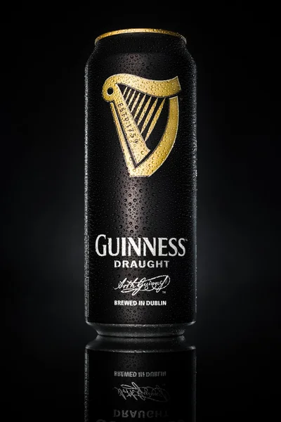 Guinness-Dose auf schwarzem Hintergrund. Stockbild