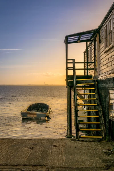 Boat and Wooden Stairs by the Sea during Sunset — 图库照片
