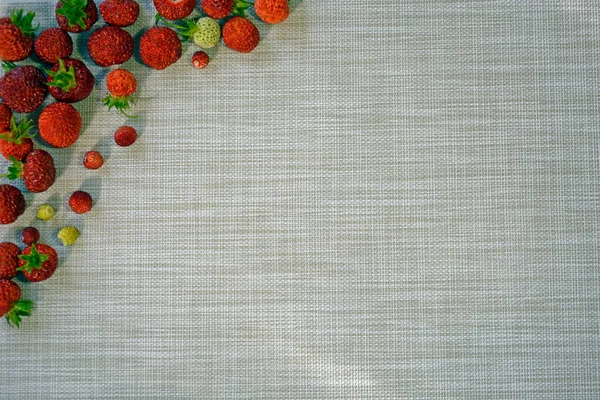 Strawberries on a gray napkin. Fruit background with empty space.