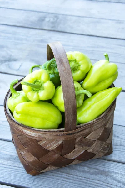 Vegetables Basket Close Wicker Basket Green Bell Peppers Stands Wooden — Stock Photo, Image