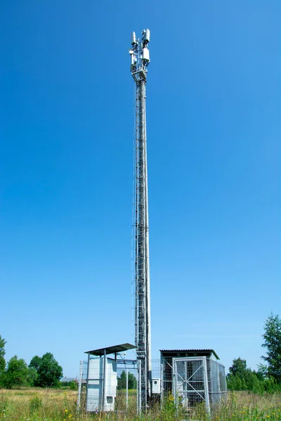 Metal pole of cellular communication. High-rise telephone pole in a field in the countryside.