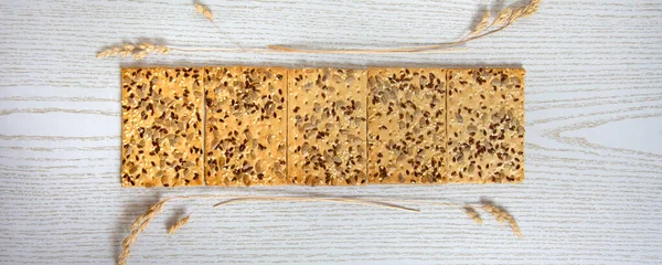 Cookie banner. Dry biscuits with sunflower seeds and dry grass stalks.
