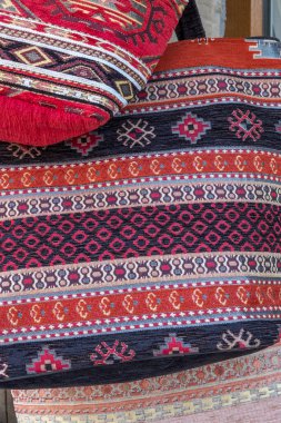 Tastefully decorated with intricate geometric patterns, these hand-crafted, cloth shoulder bags in rich tones of red and orange were for sale in Bulgarian souvenir store