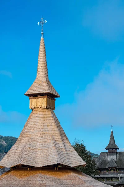 Recent roof made with dovetailed wooden shingles, displays the typical, tall form of religious buildings in the Maramures region of Romania