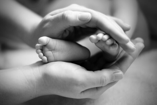New Mother Holding Newborn's Feet