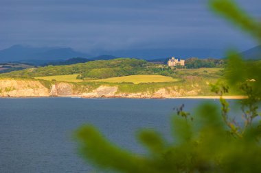 Cape Higuer 'den güneşin aydınlattığı Hendaye Lit' teki Abbadia ve Twin Rocks uçurumları