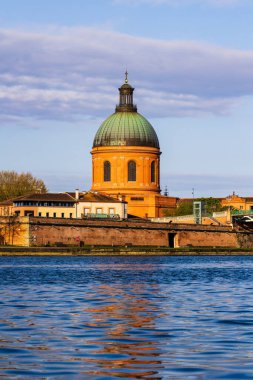 Saint-Joseph de la Grave Kilisesi 'nin kubbesi Toulouse' daki Garonne nehrinin sularına sabah ışığı altında yansıyor.