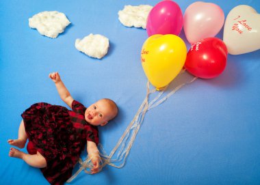 Bebek üzerinde balonlar uçuyor