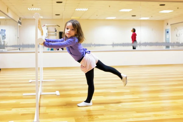 Child, a girl is engaged in ballet, gymnastics, yoga in the gym — Stock Photo, Image