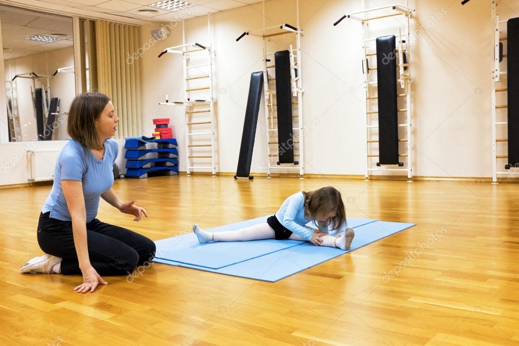 Child, a girl is engaged in ballet, gymnastics, yoga in the gym