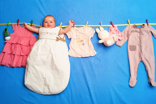 Baby in a sleeping bag is hanging on a rope