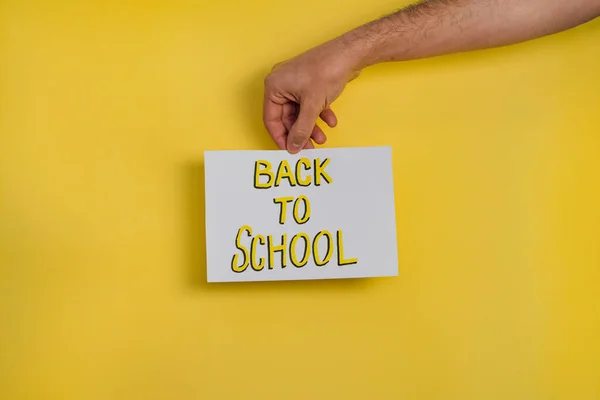 Sarı arka planda elinde 