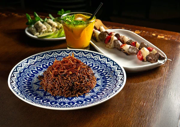 Traditional Middle Eastern food. Lebanese food. Arabian lamb barbecue, Mujadara rice and cabbage malfuf, drink