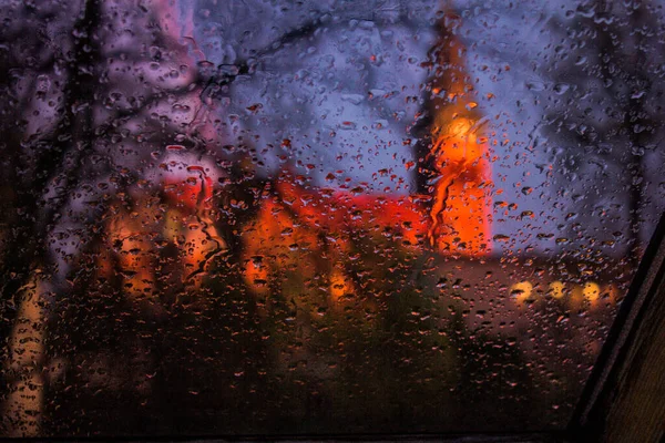 View from the window in the rain. Church through wet glass. Beautiful landscape through the rain. Background. Texture.