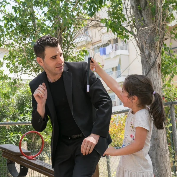 Date: 17-5-2015. Location: Park in Athens Greece. Magic trick wand falls down and brakes suddenly when the kid takes it at a Magic show. — Stock Photo, Image