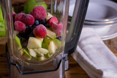 Raw fruits and berries in a mixer