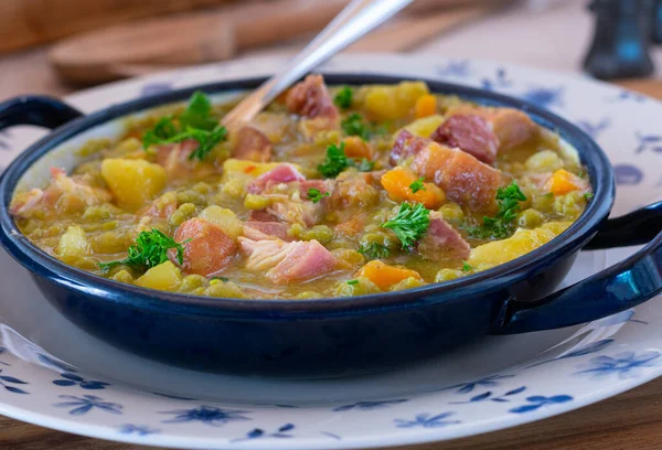 新鲜而自制的绿豆汤或豌豆炖菜 用猪肚和腊肠烹调 放在一只碗里 勺子放在乡村木桌的背景上 孤立的观点 — 图库照片