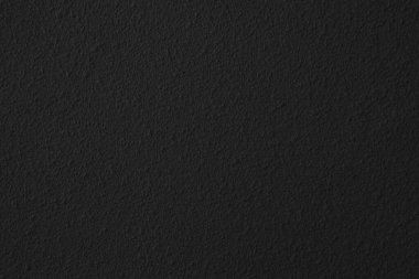 Soyut arkaplan ve tasarım amacı için doğal dokuya sahip koyu siyah beton duvar.