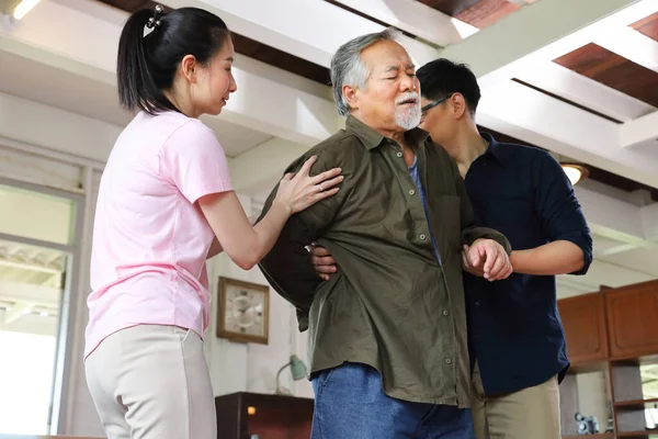 Azjatycki Starszy Mężczyzna Cierpi Ból Pleców Podczas Gdy Jego Dzieci — Zdjęcie stockowe