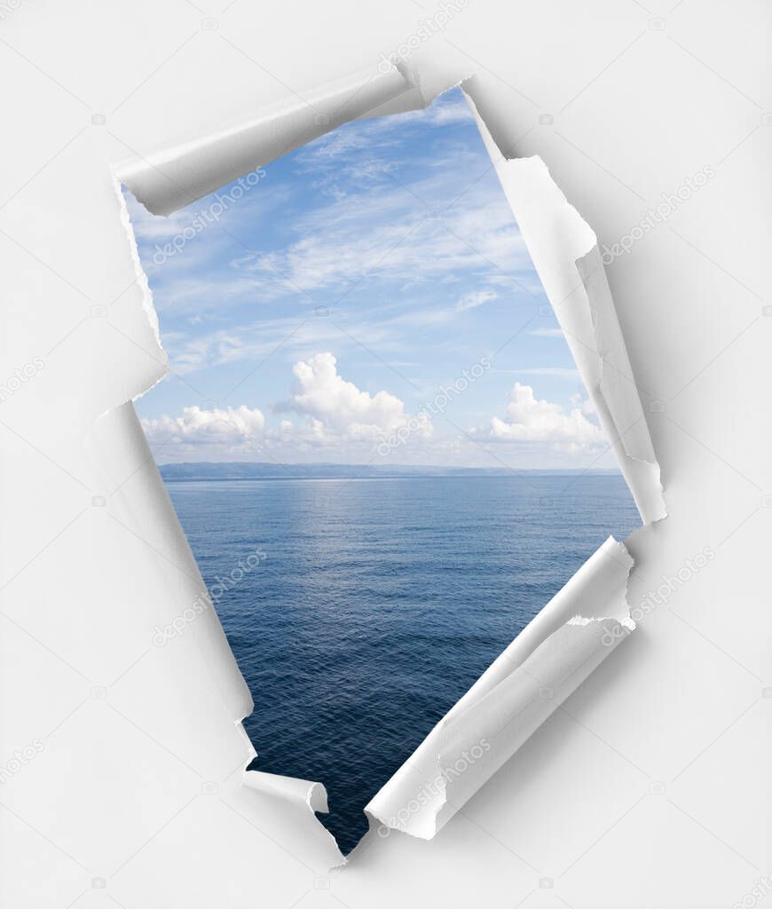 Hole paper with a relaxing seascape background. Clipping path inside