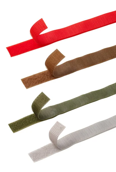 白色背景下的四个不同颜色的Velcro条 — 图库照片