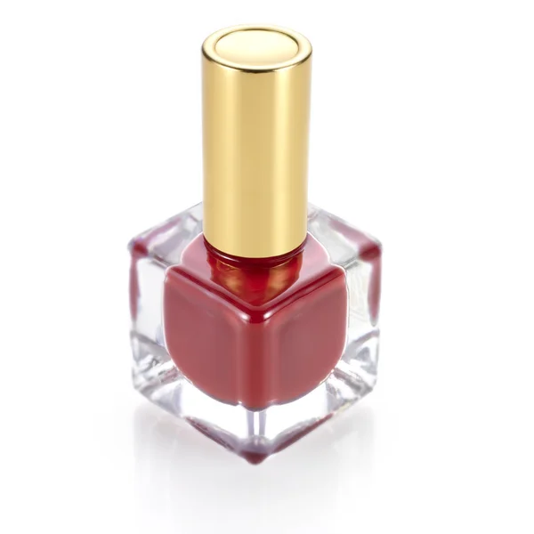 Red color nail polish bottle against white background — Φωτογραφία Αρχείου