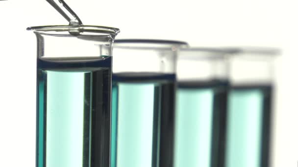 Test tube filled with bleu liquid, pouring a drop of water — Stock Video