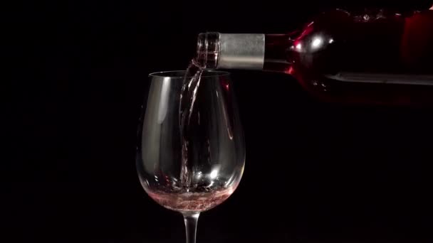 Roze wijn stroomt in glas — Stockvideo