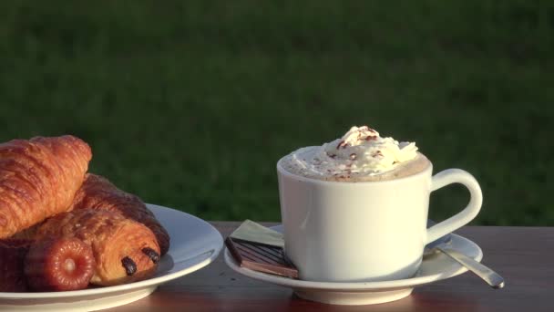 Cappuccino whith chantilly cream, croissants and pastries — Stock Video