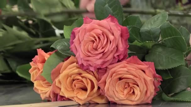 Um florista fabrica um buquê de rosas — Vídeo de Stock