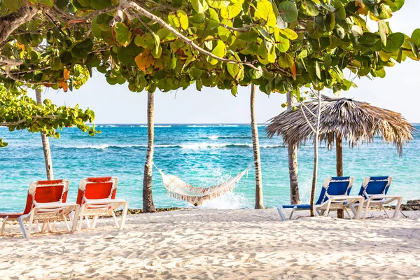 Four beach chairs and a hammock on the beach of Guardalavaca, Cuba