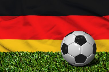 Futbol topu ile Almanya bayrağı arka plan, çimenlerin üzerinde 3d render