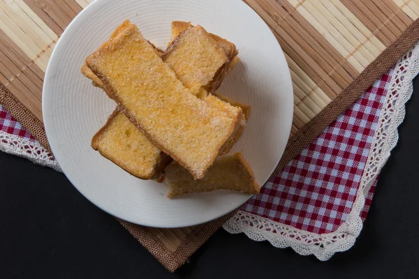 Stack of sliced crispy buttered bread with sugar — Stock Photo, Image