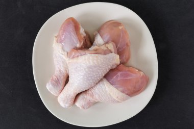 Fresh Chicken Legs on Black Background