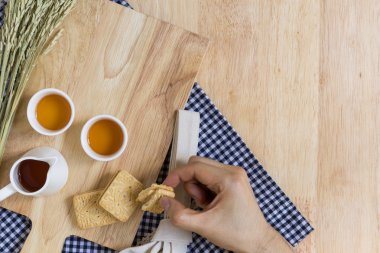 Taking Biscuit on Wood Texture Background