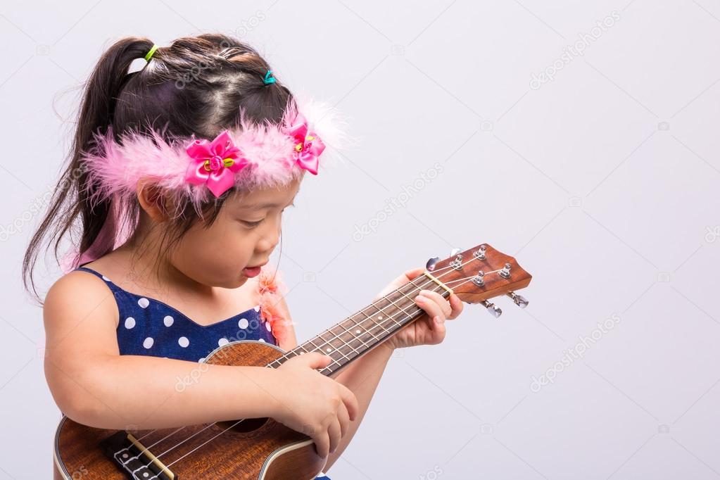 Little Girl Playing Ukulele / Little Girl Playing Ukulele Background