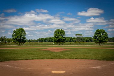Baseball Field with Blue Sky and Clouds clipart