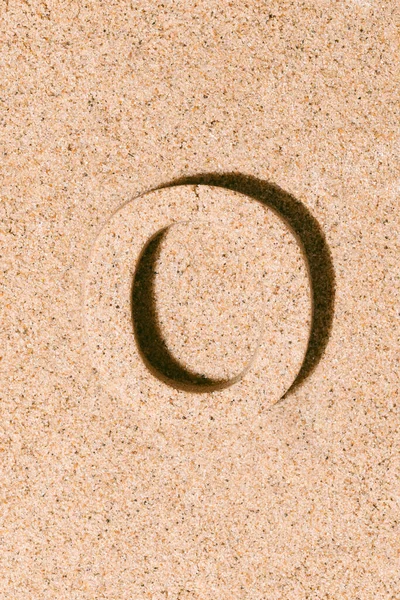 Letter O of the sand isolated on the beach sand. concept of summer. alphabet.